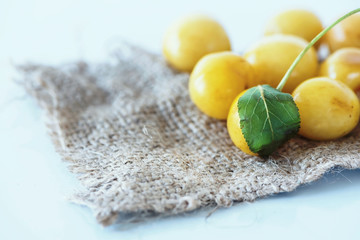 Yellow cherries on a hessian fabric, close up, macro photography