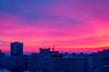 Fotobehang Fluor Roze The sunset scarlet clouds. City building  © Alexey Oblov