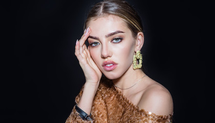 Fashion makeup, cosmetic. Spa, skincare and wellness. Stylish accessories. Fashionable jewelry. Earrings. Beautiful woman with clean perfect skin. Beautiful model girl touching her face. Copy space.