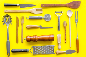 Chef work space with cookware on yellow background top view pattern