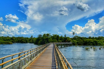 Fototapeta na wymiar Wooden Bridge with Cloudy Sky