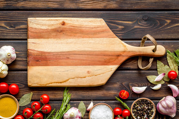 Chef work space with products and cutting board on wooden background top view mock up