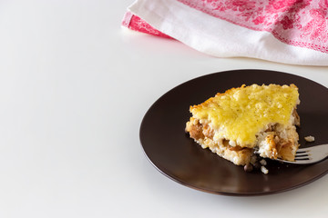 Casserole or rice and cheese pie with minced meat. Healthy dietary lunch or dinner. White background. Copy space.