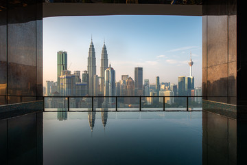 Fototapeta na wymiar Swimming pool on roof top with beautiful city view in morning at Kuala lumpur, Malaysia. Travel and Vacation concept.
