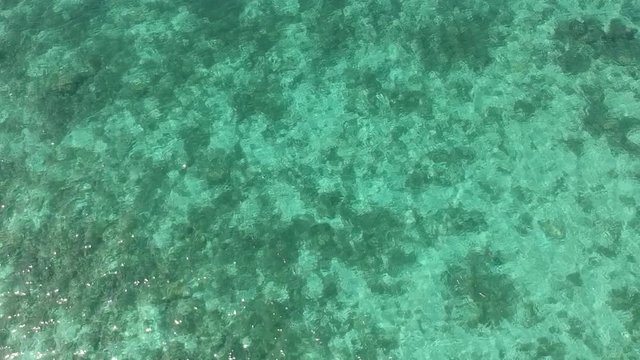 Beautiful waters of Bantayan Island in the Philippines and passing a Baroto Boat