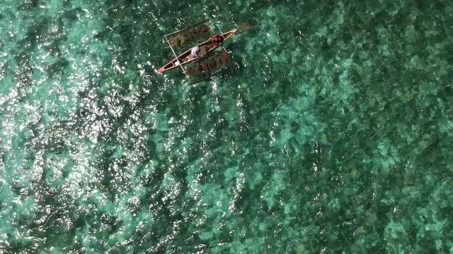 Overhead shot of a Baroto boat in the crystal clear waters of Bantayan Island in the Philippines