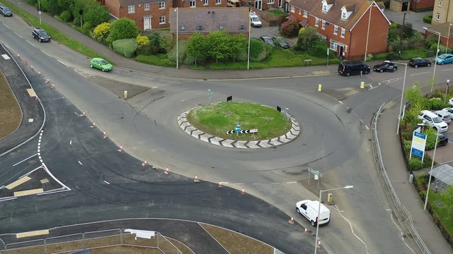Static aerial view of vehicles using a newly constructed roundabout in the UK