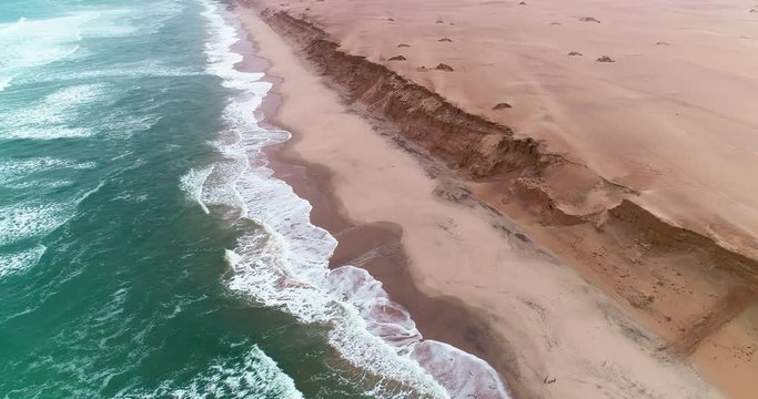 Arial birds eye view of the magnificent Namibian Skeleton Coast. Driving on the beach. The unforgiving Atlantic Ocean Waves crashes onto the shore, where many ships have lost the war.