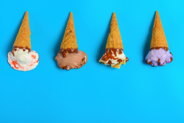 top view mini ice cream cones in a melting process on a blue background