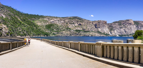 Paved road on top of O'Shaughnessy Dam; Hetch Hetchy Reservoir visible on the right; Yosemite National Park; Hetch Hetchy Valley is a source of drinking water for San Francisco Bay area, California