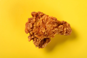 top view fresh deep fried chicken drumstick on yellow background