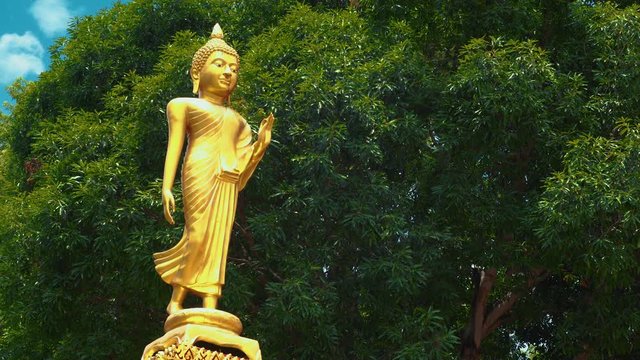 A beautifully sculpted statue of a golden female Budah stands proud in Chonburi, Thailand, Asia,