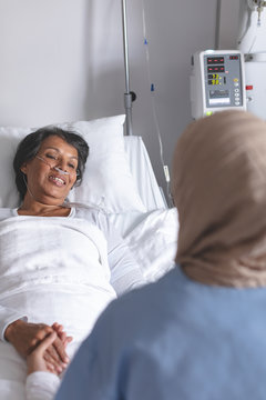 Female doctor consoling female patient in the ward