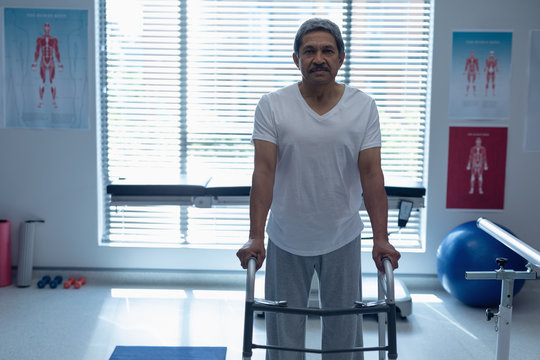 Male patient walking with walker in the ward