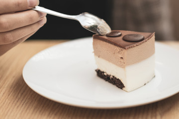 girl eating a piece of delicious chocolate cake on a white plate