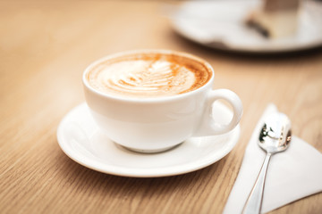 Hot coffee cappuccino latte art on wooden background