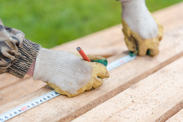 Measure with a ruler on the tree. Measure the distance with a ruler. Measure on the board. Centimeter on the tree. Construction works.