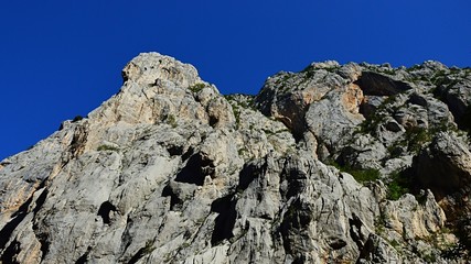 Steep cliffs with scarce vegetation during hot summer day in Paklenica National Park, Croatia