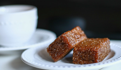Wajik on black background.  Wajik is traditional snack made with steamed glutinous (sticky) rice and further cooked in palm sugar, coconut milk, and pandan leaves.