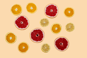 Still life with sliced ​​tropical citrus fruits: yellow lemons, red grapefruits, bright oranges. Background. View from above. Close-up.