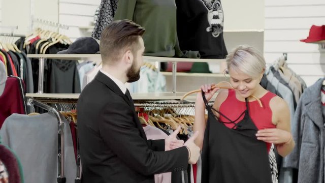 Young couple chosing clother in store