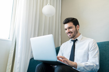 Professional Using Laptop In Hotel Room