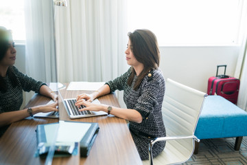 Businesswoman Working On Laptop In Hotel Room