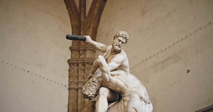Unique beautiful roman sculpture of Hercules and centaur Nessus in Loggia dei Lanzi. Amazing marble statue of Greek demigod killing the centaur. Walking in Piazza della Signoria, Florence.