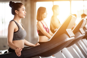Young healthy woman cardio on a treadmill at the gym