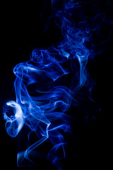 Fototapeta premium Blue toxic fumes movement on a black background.
