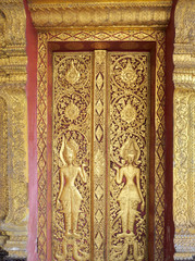 Low relief carved door "Wat Mai Suwan Phu Pha Nam" is a temple