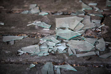 shards of broken glass on the old wooden floor