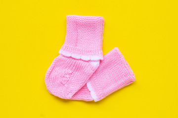 Baby socks on yellow background.
