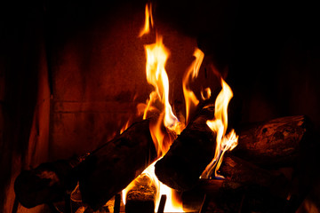 Fireplace detail with tall fire flames.