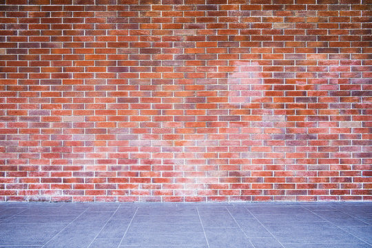 Empty brown bricks wall background and texture on vintage style with modern plate concrete floor use a side walk on exterior building architecture, nobody and copy space