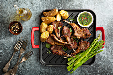 Grilled lamb chops with green herb sauce, asparagus and potatoes