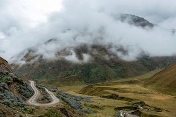Curved mountain road in misty mountains, Abra Mariano Llamoja, pass between Yanama and Totora, The Choquequirao trek, Peru