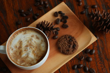 a cup of cappucino coffe on a table ready to drink