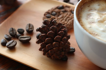 Obraz na płótnie Canvas cinnamon sticks and coffee beans on wooden table