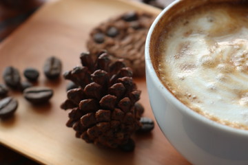 a cup of cappucino coffe on a table ready to drink