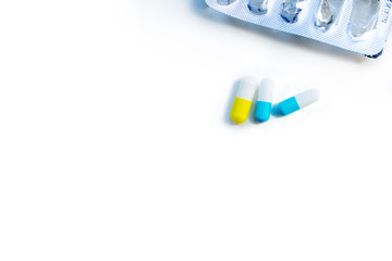 Several medical capsules and an empty blister on a white background