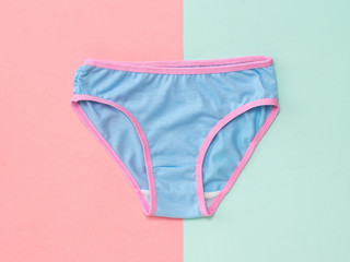 Blue women's panties on blue and pink background. The concept of meeting lovers. Underwear. The...