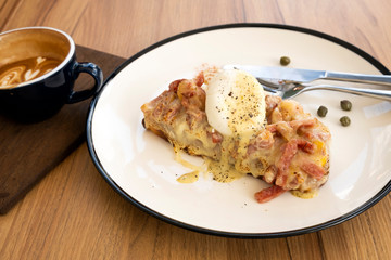 Toast, ham, bacon, cheese and fried eggs for breakfast