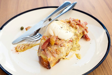 Toast, ham, bacon, cheese and fried eggs for breakfast