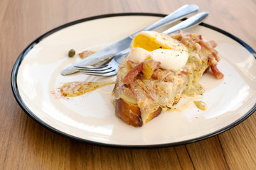 Toast, ham, bacon, cheese and fried eggs for breakfast