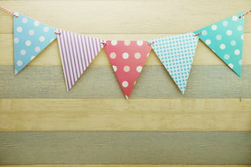 Colorful Bunting hanging with space copy on wooden background