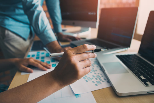 Two software developers are analyzing together about the code written into the program on the computer.