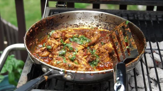 Cooking Tava chicken or skillet Chicken , an appetizer outdoors in a pan on coal