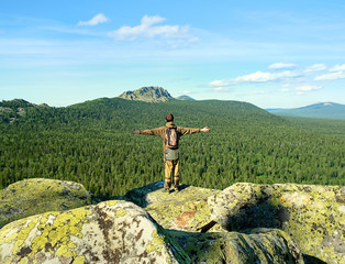 Natural landscape with tourist and mountain rocks, slopes of Southern Urals. Beautiful view from top of rock mountain in Urals. summer landscape in mountains. theme for travel backdrop. soft focus