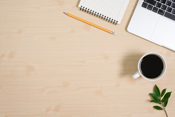 Flay lay, Top view office table desk with computer laptop, keyboard, coffee, pencil, leaves with copy space wood background.